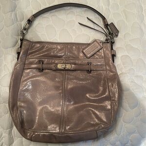 Coach Chelsea Shimmery Leather Shoulder Bag blends elegance with modern glamour.